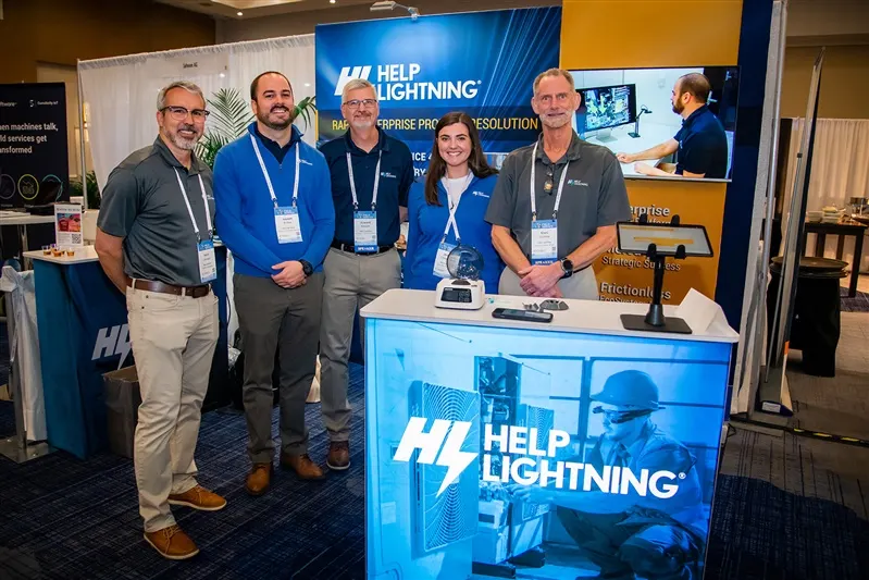 Five teammates at a Help Lightning booth under a Rapid Enterprise Problem Resolution banner.